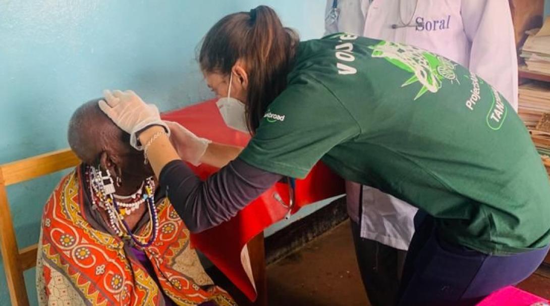 A medical volunteer does a basic health check under the supervision of a local doctor in Tanzania.